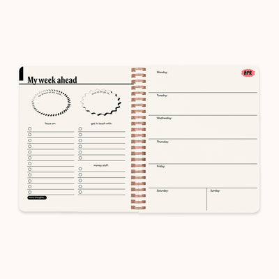 Weekly planner with a spiral binding on a white background